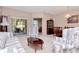 Cozy living room featuring comfortable floral furniture and sliding glass doors to the lanai at 9317 Stone River Pl, Riverview, FL 33578
