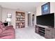 Inviting living room with cozy seating, bookshelf, and entertainment center at 9317 Stone River Pl, Riverview, FL 33578