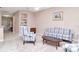 Comfortable living room with neutral walls, carpet, built-in shelving, and floral-patterned furniture at 9317 Stone River Pl, Riverview, FL 33578