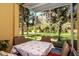 Relaxing screened patio with a table, chairs, and views of a lush garden at 9317 Stone River Pl, Riverview, FL 33578