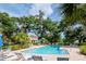 Enjoy the community's sparkling pool surrounded by lush landscaping and comfortable lounge chairs at 9317 Stone River Pl, Riverview, FL 33578