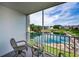 Enjoy serene water views from this screened balcony with comfortable seating and a peaceful outlook at 960 Virginia St # 204, Dunedin, FL 34698