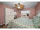 Comfortable bedroom features a ceiling fan, mirrored closet doors, and a floral-patterned comforter at 960 Virginia St # 204, Dunedin, FL 34698