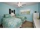Bright bedroom with matching twin beds and light blue walls at 960 Virginia St # 204, Dunedin, FL 34698