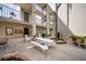Condo courtyard features picnic table, BBQ, and lush landscaping with palm trees at 960 Virginia St # 204, Dunedin, FL 34698