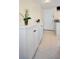 Hallway area featuring tiled floors and white storage cabinets at 960 Virginia St # 204, Dunedin, FL 34698