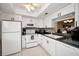 Bright kitchen featuring white cabinets, countertops, and modern appliances at 960 Virginia St # 204, Dunedin, FL 34698