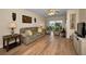 Inviting living room with hardwood floors, neutral tones, and sliding glass doors to balcony at 960 Virginia St # 204, Dunedin, FL 34698