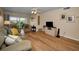 Open living room with hardwood floors, access to the balcony, and a ceiling fan at 960 Virginia St # 204, Dunedin, FL 34698