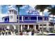 Vibrant stadium with palm trees and a bustling crowd at 960 Virginia St # 204, Dunedin, FL 34698