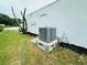 A Runtru air conditioner system sits outside the home near a cactus at 3516 Norland Ct, Holiday, FL 34691