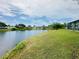 Water view backyard with screened-in patio at 3516 Norland Ct, Holiday, FL 34691