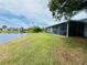 Water view backyard with screened-in patio at 3516 Norland Ct, Holiday, FL 34691