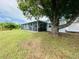 Water view backyard with screened-in patio near a large shade tree at 3516 Norland Ct, Holiday, FL 34691