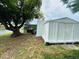 Water view backyard with screened-in patio and storage shed at 3516 Norland Ct, Holiday, FL 34691