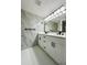 Stylish bathroom featuring a double vanity, modern fixtures, and elegant tile work at 3516 Norland Ct, Holiday, FL 34691