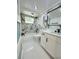 Bathroom featuring marble accent wall, white vanity and modern fixtures at 3516 Norland Ct, Holiday, FL 34691