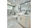 Bathroom featuring marble accent wall, white vanity and modern fixtures at 3516 Norland Ct, Holiday, FL 34691