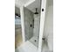 Modern bathroom featuring a tiled shower with rainfall showerhead and a mosaic floor at 3516 Norland Ct, Holiday, FL 34691