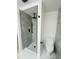 Modern bathroom featuring sleek black fixtures and a stylish shower with gray tiling and mosaic floor at 3516 Norland Ct, Holiday, FL 34691