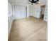 Bright bedroom with wood-look flooring, ceiling fan and ample closet space at 3516 Norland Ct, Holiday, FL 34691