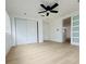 Bright bedroom with wood-look flooring, ceiling fan and ample closet space at 3516 Norland Ct, Holiday, FL 34691