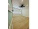 A bright, airy bedroom features neutral walls, wood floor and a modern ceiling fan at 3516 Norland Ct, Holiday, FL 34691