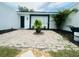 Home entrance featuring a brick-paved patio with a potted plant at 3516 Norland Ct, Holiday, FL 34691