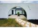 Exterior view framed by an archway, showcasing the home's entrance at 3516 Norland Ct, Holiday, FL 34691