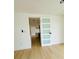 Bright hallway featuring modern doors and light wood flooring, leading to other areas of the home at 3516 Norland Ct, Holiday, FL 34691