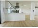 Stylish kitchen features white countertops, stainless appliances, and a modern range hood, great for culinary enthusiasts at 3516 Norland Ct, Holiday, FL 34691
