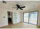 Bright living room featuring wood-look floors, ceiling fan, and sliding glass doors at 3516 Norland Ct, Holiday, FL 34691
