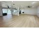 Bright, open-concept living space features new flooring and ample natural light, adjacent to a modern kitchen at 3516 Norland Ct, Holiday, FL 34691