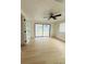Bright living room featuring wood-look floors, ceiling fan, and sliding glass doors at 3516 Norland Ct, Holiday, FL 34691