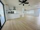 Open-plan living area with sleek floors and lots of light, featuring an adjacent contemporary kitchen and water views at 3516 Norland Ct, Holiday, FL 34691