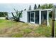 A screen enclosed porch is attached to the rear of this home at 3516 Norland Ct, Holiday, FL 34691