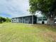 A screen enclosed porch with hot tub is attached to the rear of the house at 3516 Norland Ct, Holiday, FL 34691