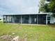 A screen enclosed porch with hot tub is attached to the rear of the house at 3516 Norland Ct, Holiday, FL 34691