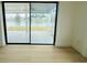 Enclosed sun room with expansive windows offering serene lake views and access to outdoor space at 3516 Norland Ct, Holiday, FL 34691