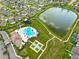 A full community aerial view with pool, tennis court, parking and large community pond at 10211 Cakebread Ln, Riverview, FL 33578