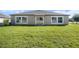The backyard has well-maintained green grass and a sliding glass door at 10211 Cakebread Ln, Riverview, FL 33578