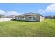 The backyard has well-maintained green grass, windows, and a patio at 10211 Cakebread Ln, Riverview, FL 33578