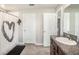 Bathroom featuring a shower with heart decorated shower curtain and wood cabinets at 10211 Cakebread Ln, Riverview, FL 33578