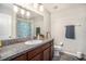This bathroom has granite countertops, a large mirror, and towel racks at 10211 Cakebread Ln, Riverview, FL 33578
