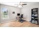 Bedroom featuring hardwood floors, ceiling fan, natural light, and decor shelving at 10211 Cakebread Ln, Riverview, FL 33578