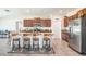 Spacious kitchen with granite countertops, stainless steel appliances and four bar stools at the island at 10211 Cakebread Ln, Riverview, FL 33578