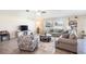 Spacious living room filled with natural light, comfortable seating, and tiled floors, creating an inviting atmosphere at 10211 Cakebread Ln, Riverview, FL 33578