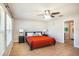 Spacious main bedroom with hardwood floors, ceiling fan, and an ensuite bathroom at 10211 Cakebread Ln, Riverview, FL 33578