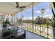 Screened balcony with furniture offers an expansive view of tropical trees and manicured landscaping at 1060 N Shore Ne Dr # 6, St Petersburg, FL 33701