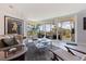 Living room with floor to ceiling windows and access to screened balcony with garden view at 1060 N Shore Ne Dr # 6, St Petersburg, FL 33701